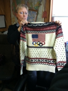 On Jan. 20, 2014, Debbie McDermott of Stonehedge Fiber Mill in East Jordan, Mich,, holds up one of the sweaters to be worn by Team USA in the 2014 Winter Olympics. The mill prepared the yarn for the Olympic sweaters and hats designed by Ralph Lauren. 